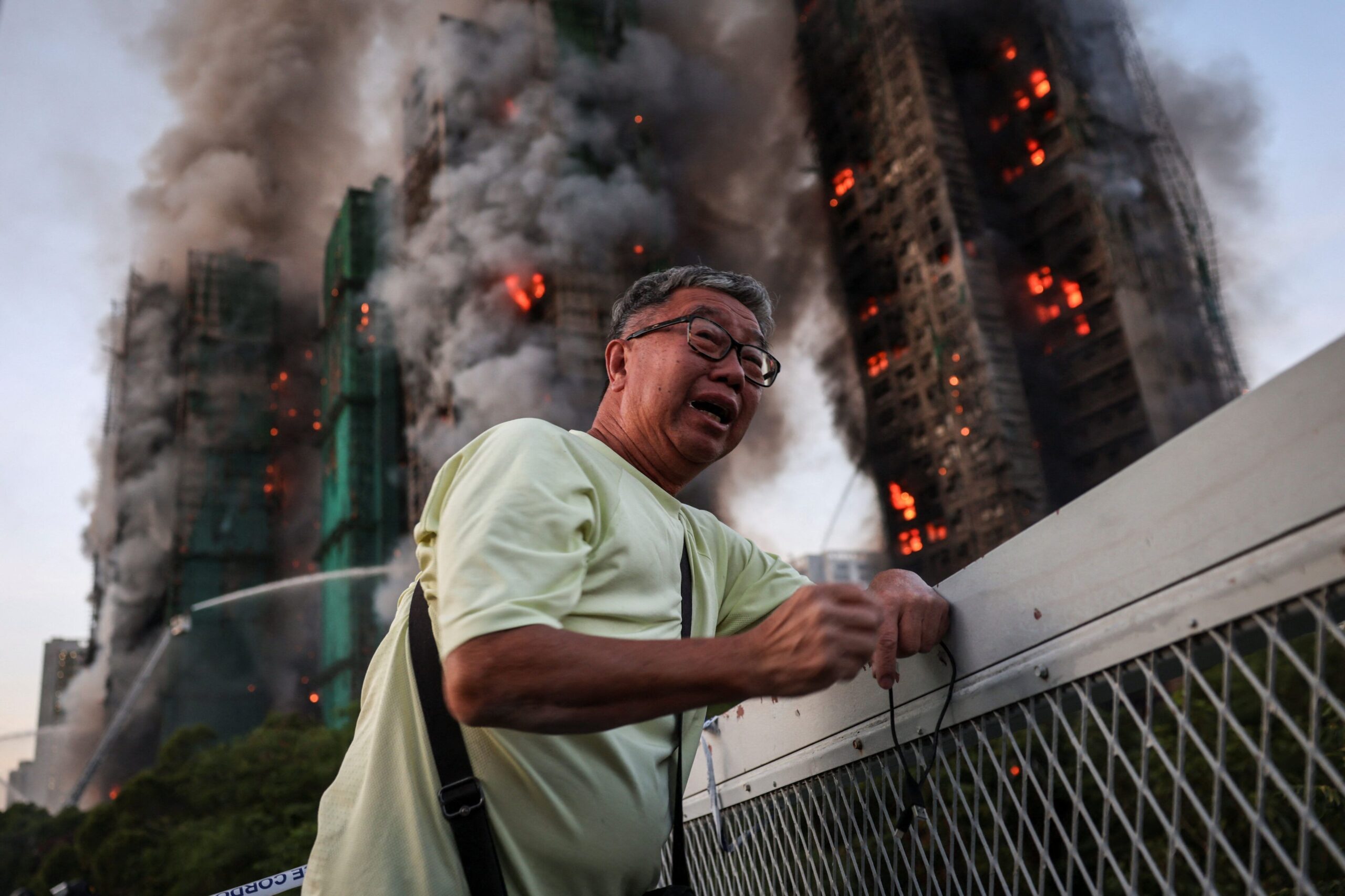 Wong, 71, reacts after saying his wife is trapped inside Wang Fuk Court. Reuters