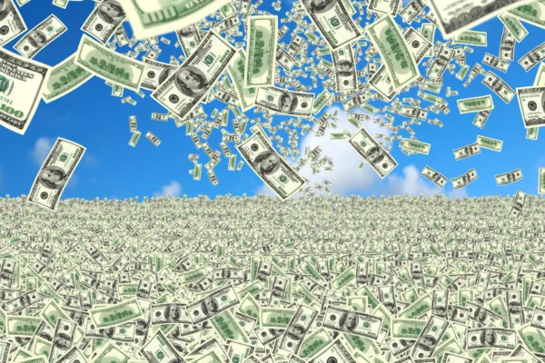 $100 bills falling from the sky into a field of money.