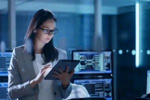 An IT professional checks a tablet computer in a data center.