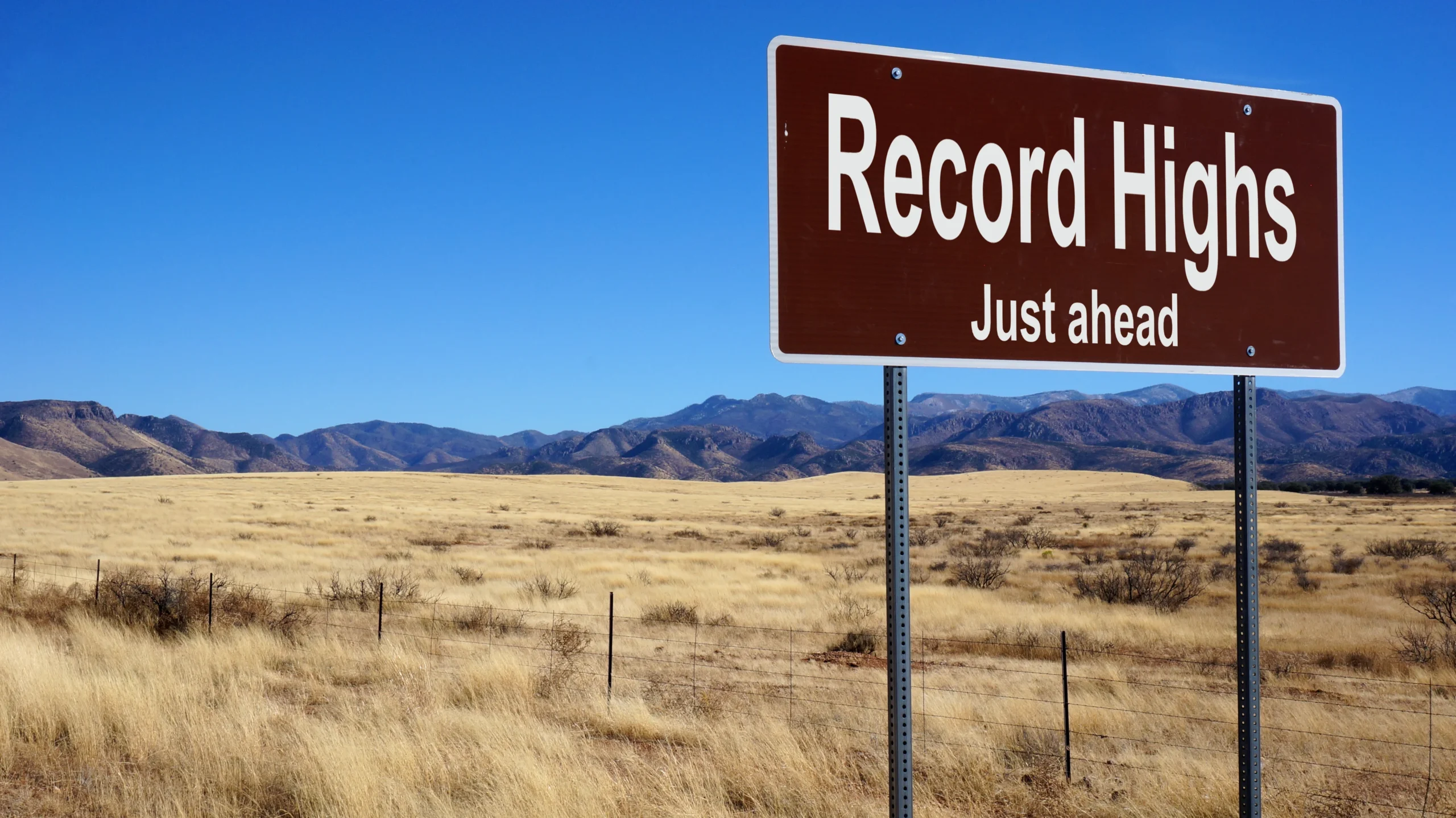 A road sign that reads "Record Highs Just Ahead"