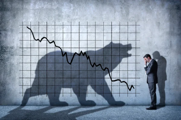 Silhouette of a bear with a stock market crash chart.
