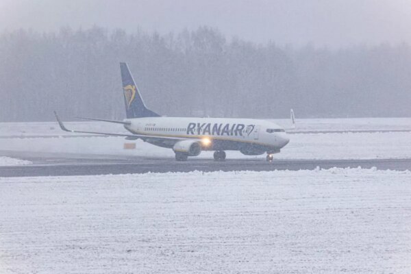 A Boeing 737-800 aircraft of the Irish low cost carrier Ryanair is landing and taxiing during a previous snow storm