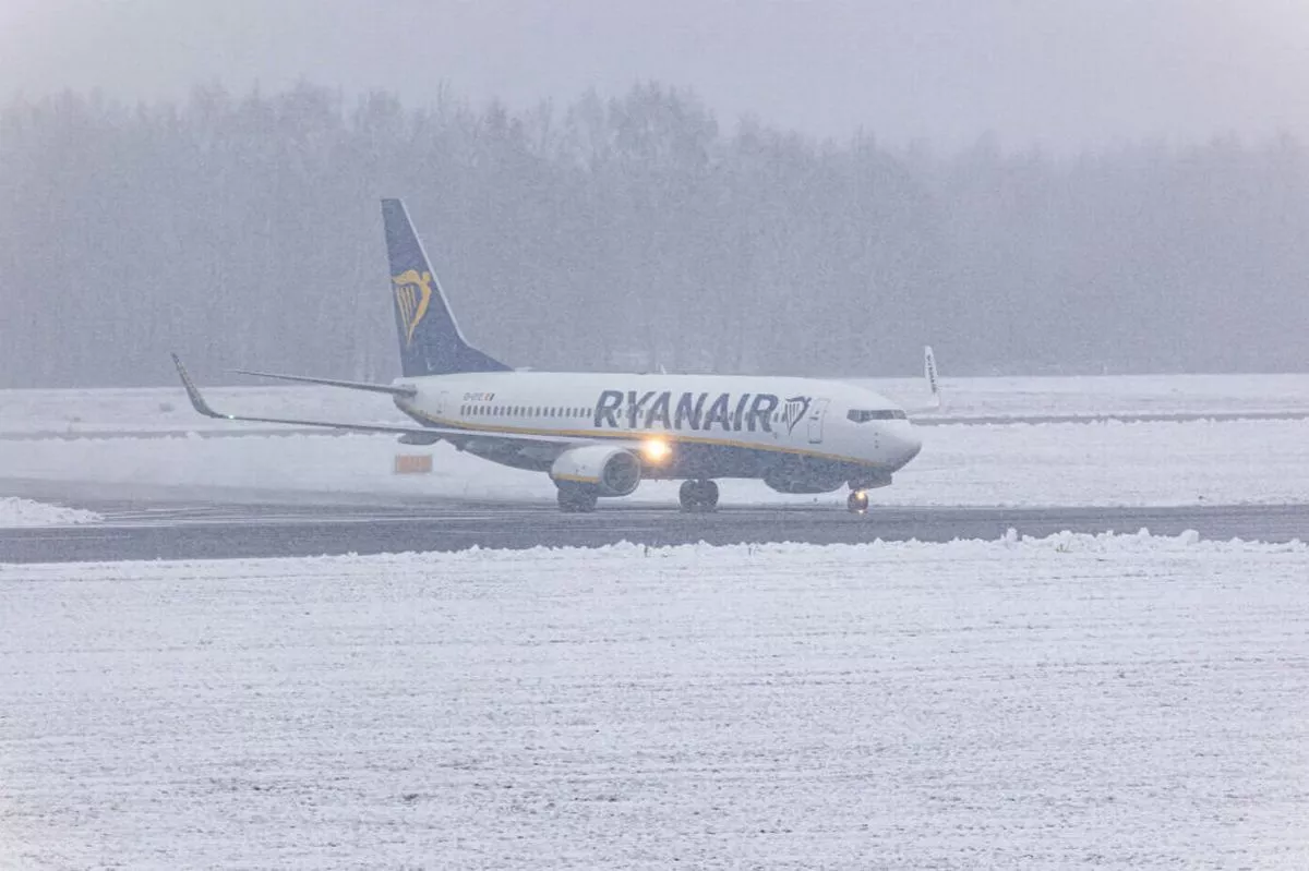 A Boeing 737-800 aircraft of the Irish low cost carrier Ryanair is landing and taxiing during a previous snow storm