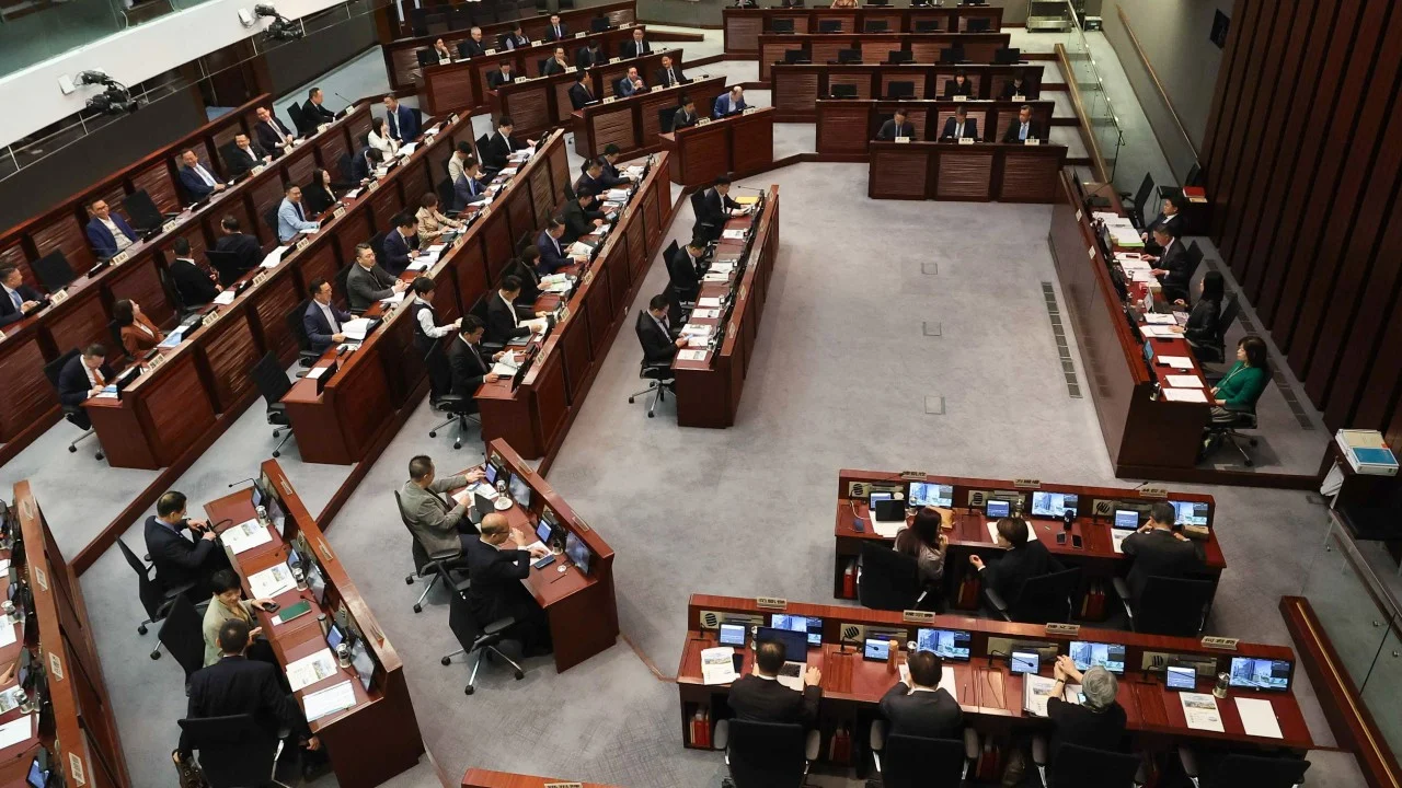 Hong Kong’s finance chief warns of market volatility, pledges support for families