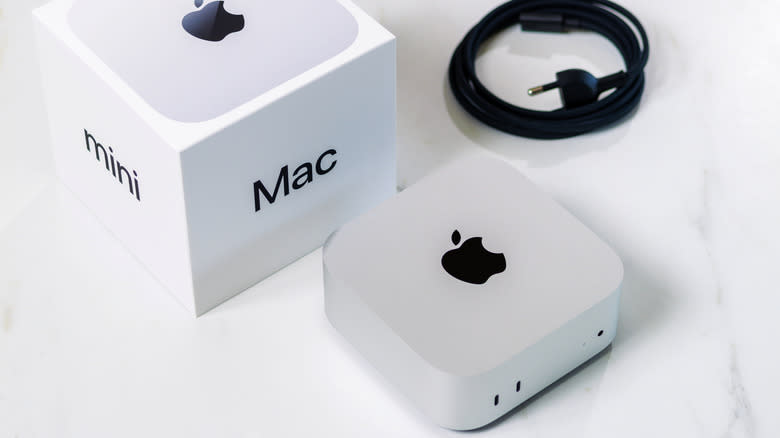 Apple Mac mini on table with box and accessories