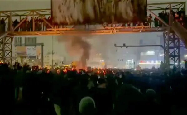 A crowd of people protesting on the streets of Tehran