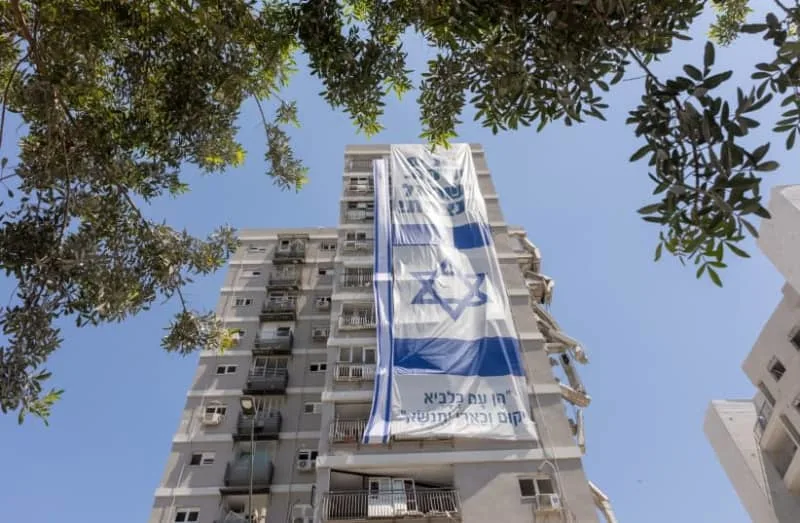 Volunteers clean and evacuate apartments that were hit by the Iranian missiles during the war between Iran and Israel, in Bat Yam. July 03, 2025. (credit: Dor Pazuelo/Flash90)