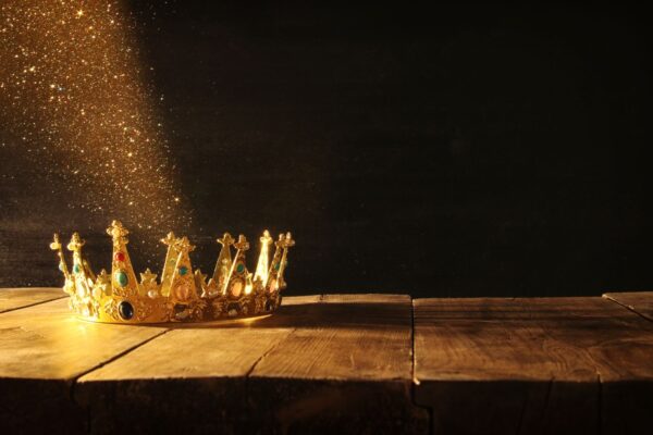 A gold crown with sparkling dust by tomertu via Shutterstock