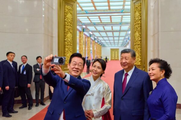 TOPSHOT - South Korea's President Lee Jae Myung (L) and his wife Kim Hea Kyung (2nd L) take a selfie with China's President Xi Jinping (2nd R) and his wife Peng Liyuan (R) after a dinner at the Great Hall of the People in Beijing on January 5, 2026.