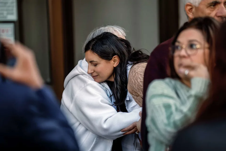 Monica Tagas hugs a family member following a court hearing in the case against her father, Michael Anthony Leon, who is accused of killing his wife and allegedly staging the murder to look like a suicide. (Carlos Avila Gonzalez/S.F. Chronicle)