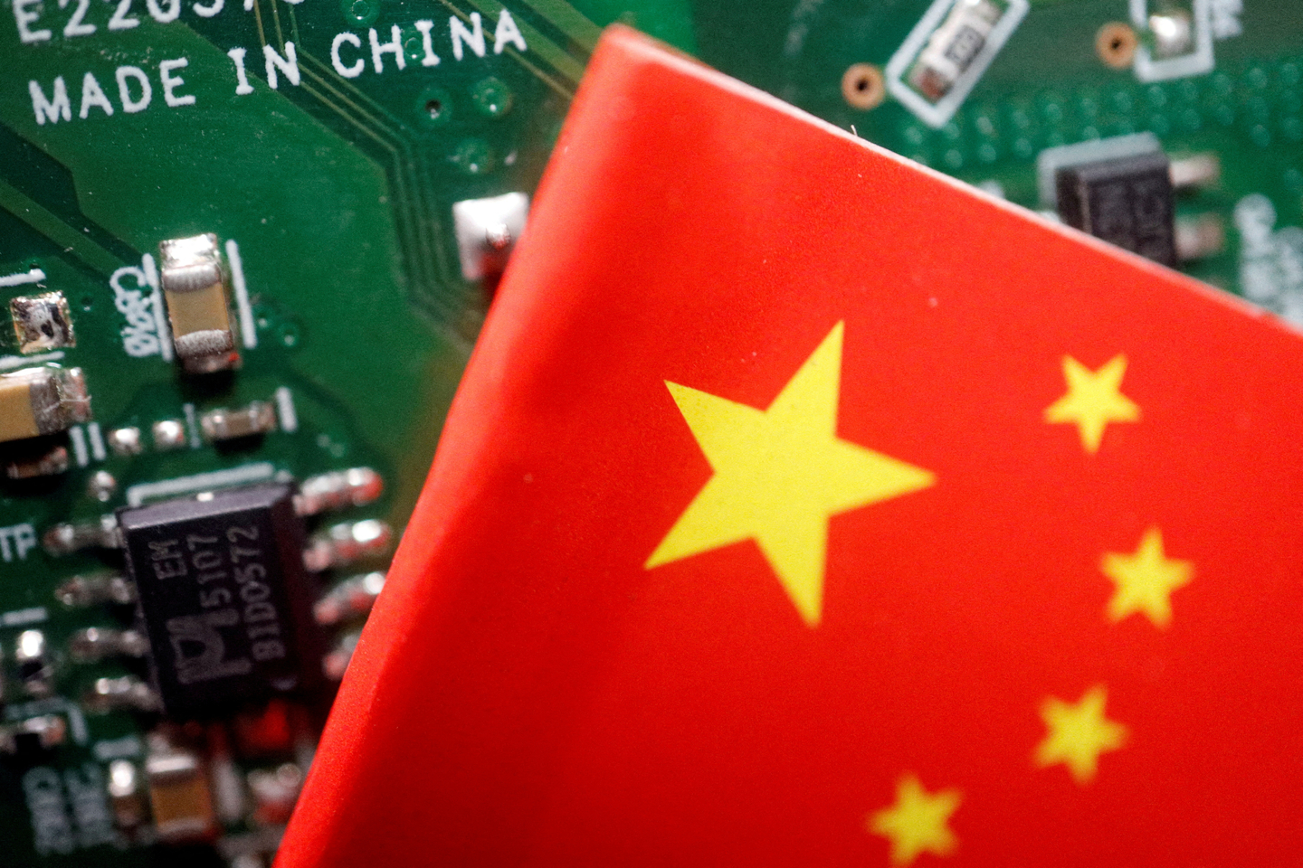 A Chinese flag is displayed next to ″Made in China″ marking on a printed circuit board in this illustration from Feb. 17, 2023. [REUTERS/YONHAP]