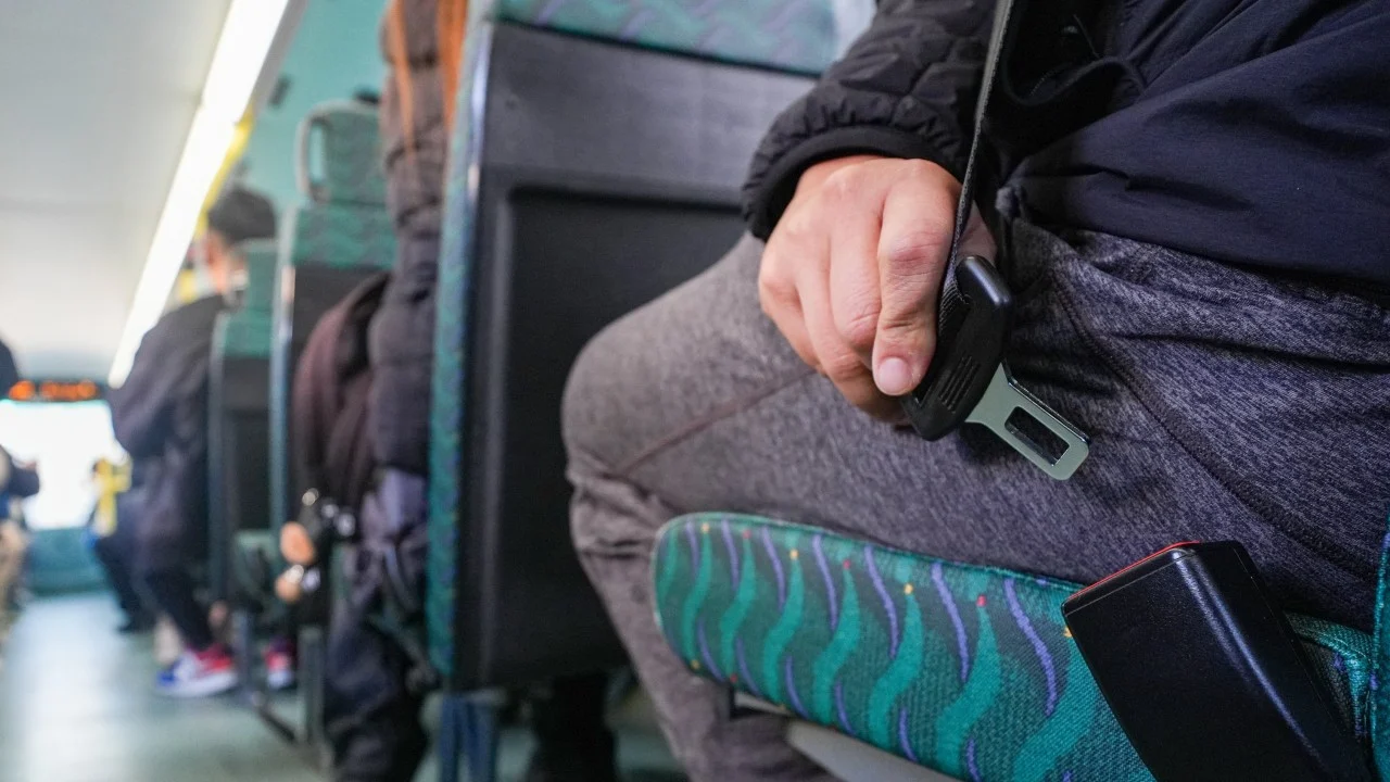Crowds on lower decks of Hong Kong buses on first day of mandatory seat belt rule