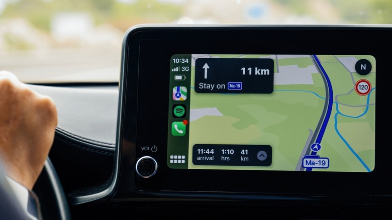 Driving a car using GPS navigation.