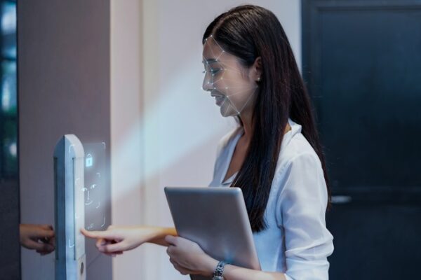 Facial recognition kiosk showing facial data points on person