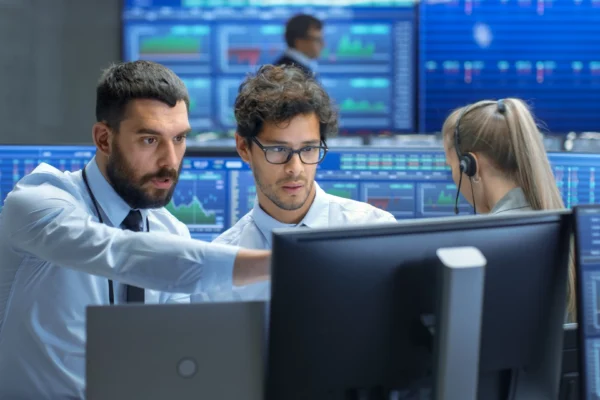 People looking at computer monitor.