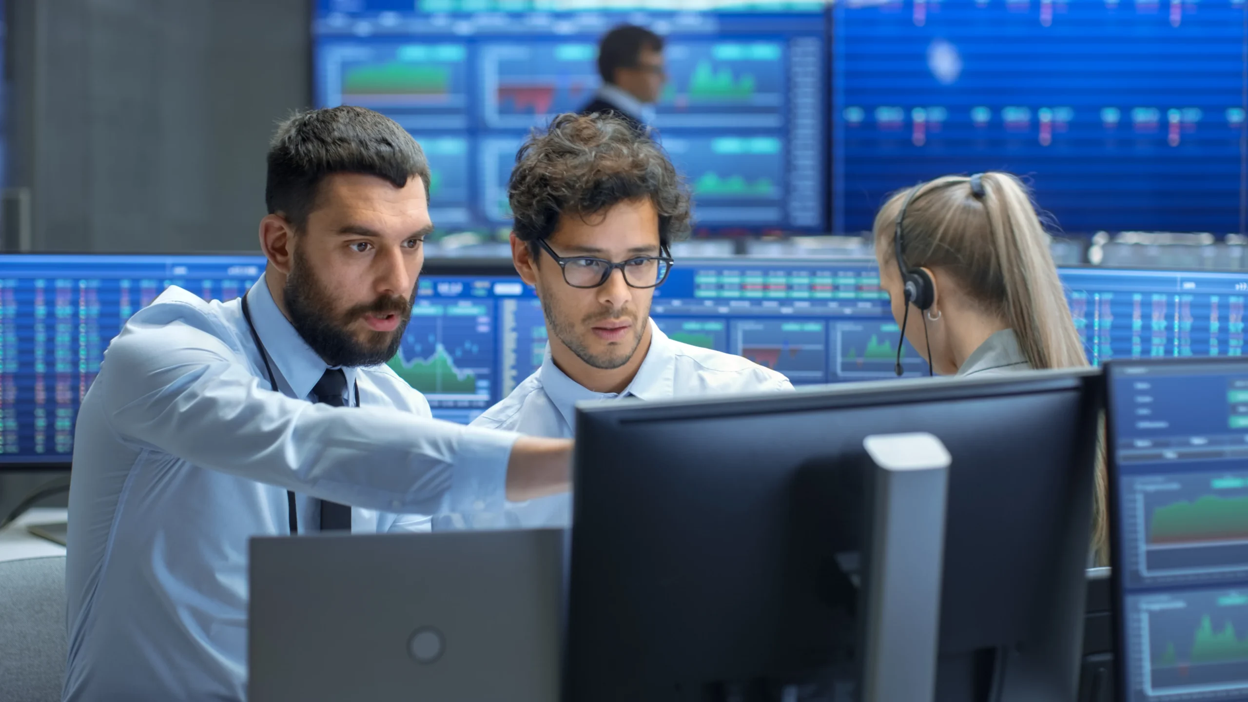 People looking at computer monitor.