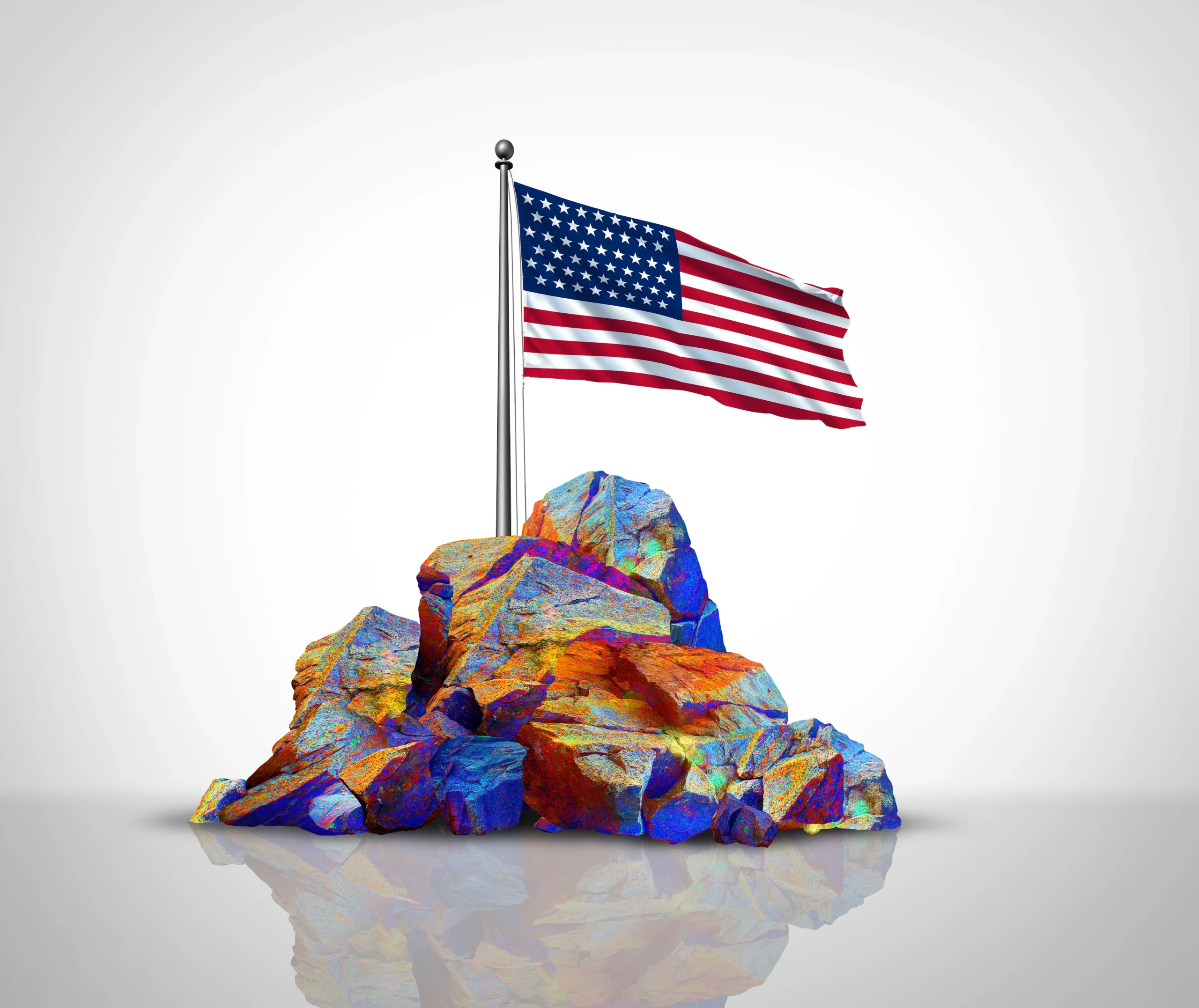 Pile of rare earth magnet minerals with U.S. flag flying on top.