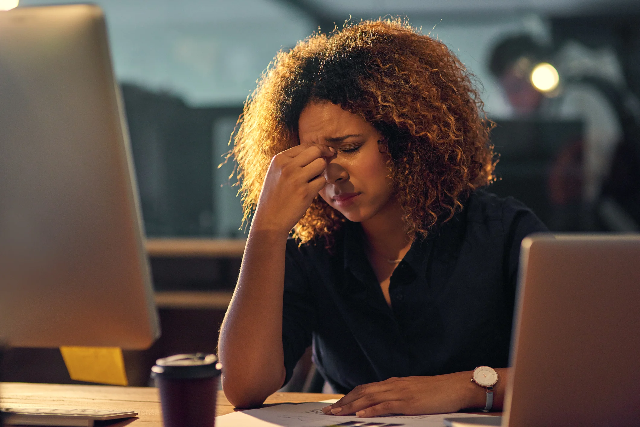 Exasperated-looking person sitting in front of laptop.