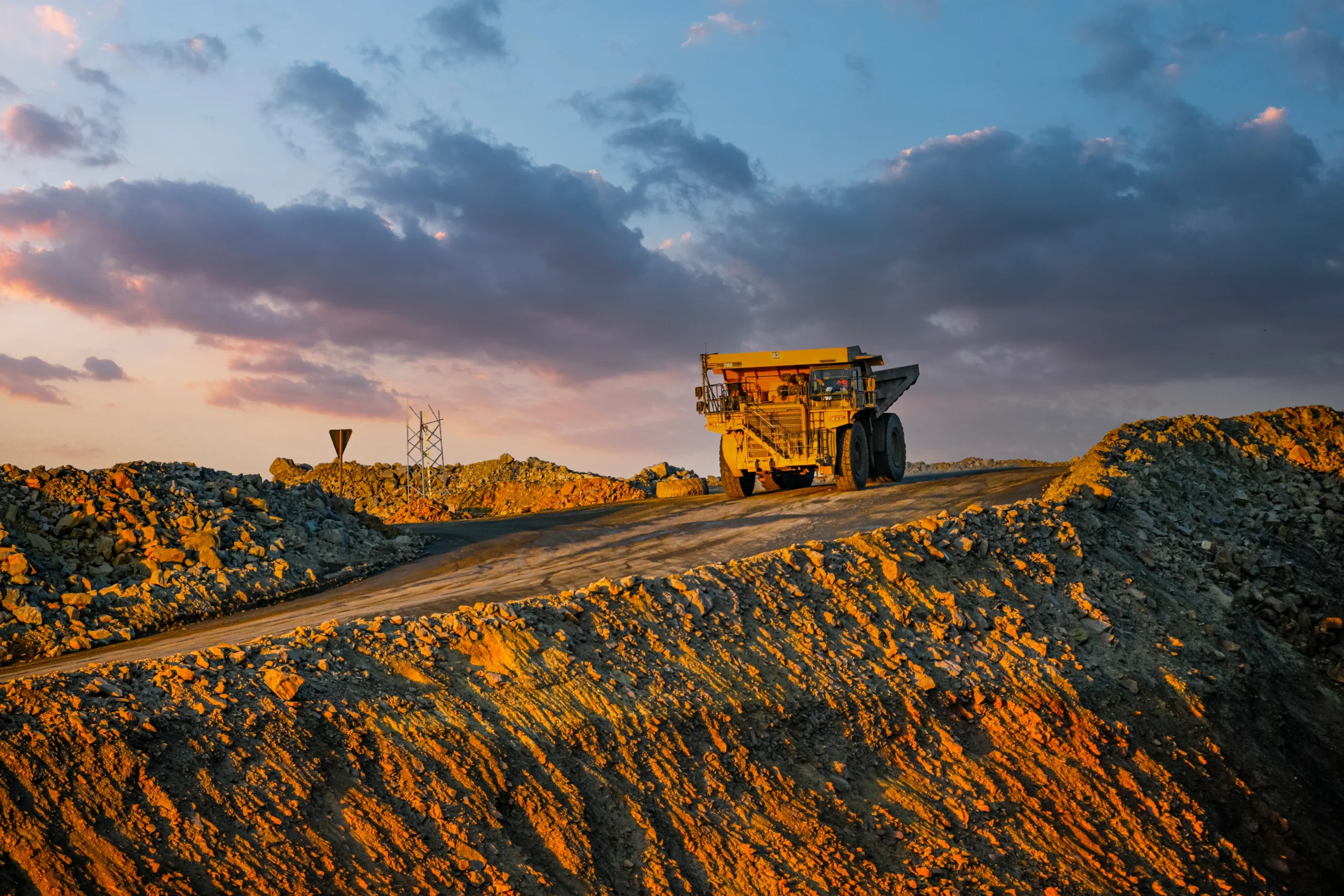 A truck driving at a mine in the early morning