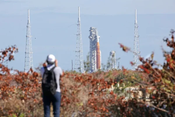 NASA's Artemis II Space Launch System (SLS) rocket and Orion spacecraft are seen in the distance at Launch Pad 39B at Kennedy Space Center in Cape Canaveral, Florida. / Credit: Gregg Newton /AFP via Getty Images