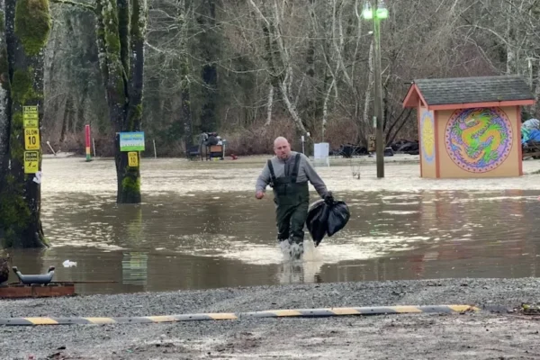 A person is seen at the flooded Maple Pool Campground near Courtenay, B.C., on Jan. 30, 2026.