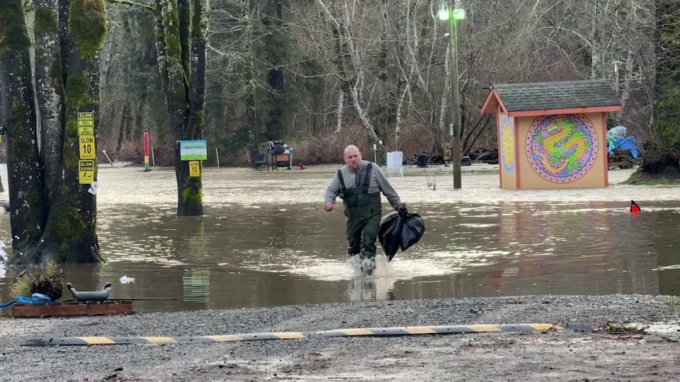 A person is seen at the flooded Maple Pool Campground near Courtenay, B.C., on Jan. 30, 2026.