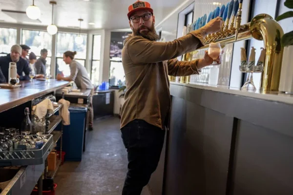 Austin Harrington, owner of Craft & Logic Taproom in Truckee, pours a beer for a customer Sunday. (Stephen Lam/S.F. Chronicle)