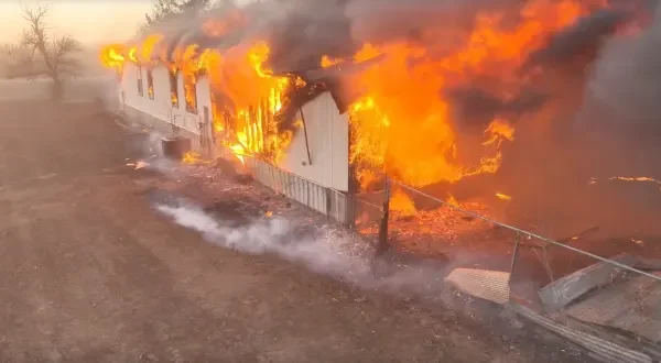 Flames consume a home in western Oklahoma on Feb. 17, 2026 after the Range Road Fire exploded in size.