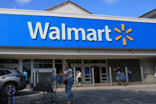 HOLLYWOOD, FLORIDA - NOVEMBER 20:  A Walmart sign hangs on the exterior of the store on November 20, 2025 in Hollywood, Florida. The retailer reported earnings per share of 62 cents and revenues of $179.5 billion through its latest quarter, sending the stock up more than 5.6% to above $106 shortly after trading opened.  (Photo by Joe Raedle/Getty Images)