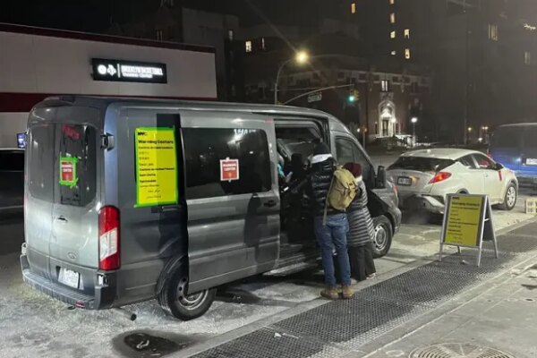 A warming van was parked outside the Barclays Center in downtown Brooklyn on Saturday night as temperatures in New York City hovered above zero. (Julian Roberts-Grmela / NY Daily News)