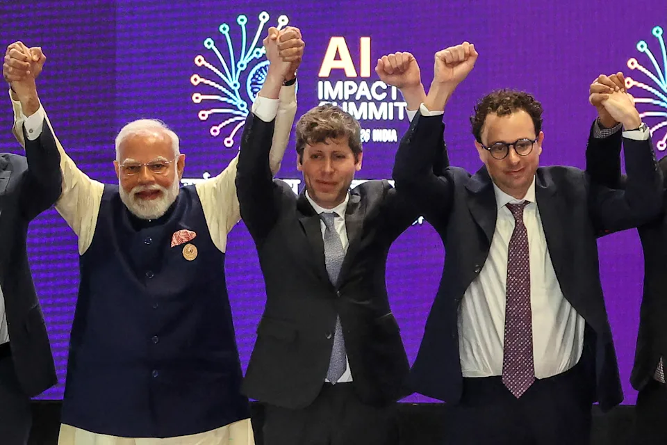 India's Prime Minister Narendra Modi (L) takes a group photo with AI company leaders including OpenAI CEO Sam Altman (C) and Anthropic CEO Dario Amodei (R) at the AI Impact Summit in New Delhi on February 19, 2026.