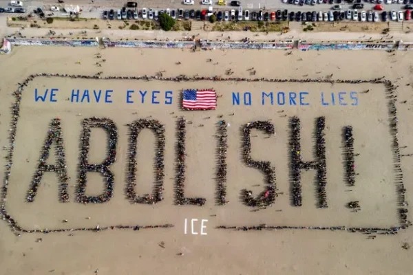 Protesters form a human banner on Ocean Beach in San Francisco in protest of ICE on Saturday.