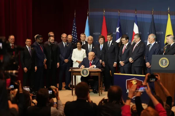 President Trump signing a proclamation while surrounded by people