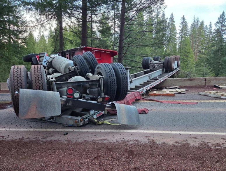 A semi-truck hauling millions of bees overturned near Crater Lake on March 17, blocking the highway and scattering hundreds of bee boxes across the road.