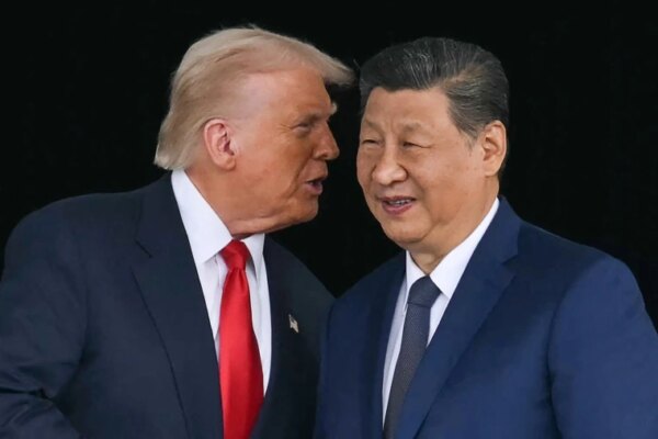 President Donald Trump talks to China's President Xi Jinping after their talks at the Gimhae Air Base in Busan, South Korea, on October 30, 2025.
