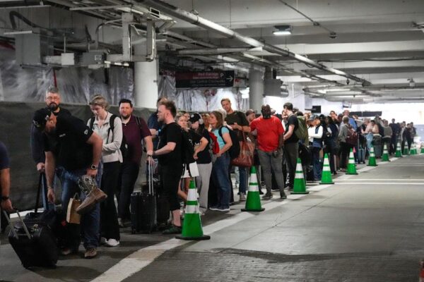 Passengers in parking garage where TSA line is.