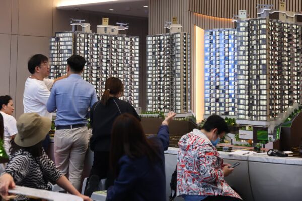 Home buyers inspect a model of a new development at a sales office in Tuen Mun, November 25, 2025. Photo: Dickson Lee