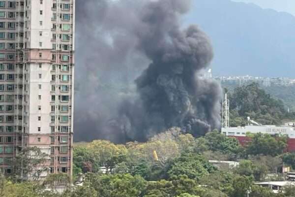 Thick black smoke rises high into the sky above the Tai Po site. Photo: Handout