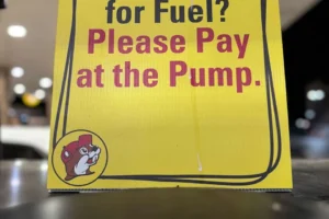 A sign at the pump at Buc-ee's notifies customers of a new policy requiring card users to pay for fuel at the pump starting March, 1 2026. (Frank Cardenas/MySA)