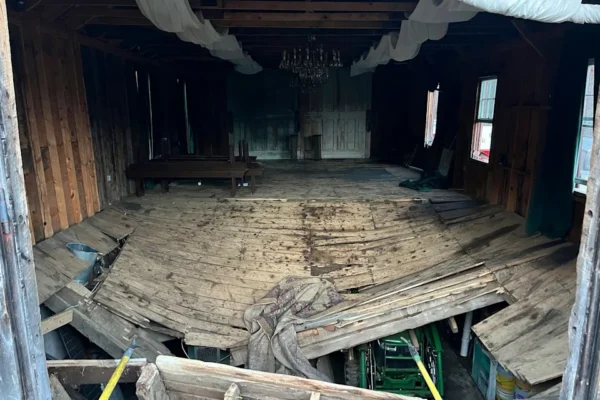 The buckled floor that collapsed, sending nearly 70 wedding guests into the basement of a building (New Hampshire State Fire Marshal's Office via AP)