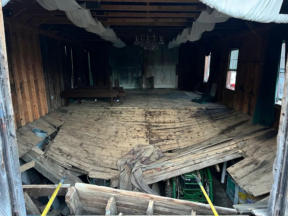 The buckled floor that collapsed, sending nearly 70 wedding guests into the basement of a building (New Hampshire State Fire Marshal's Office via AP)
