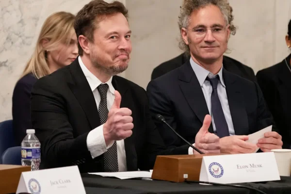 Elon Musk, X and Tesla, CEO, left, gives a thumbs up to a reporters question, sitting next to Alex Karp, Palantir on Sept. 13, 2023 in Washington DC.