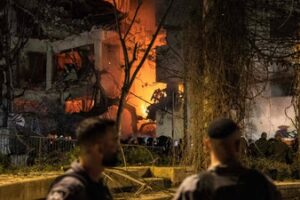 Israeli security forces stand in front of the site of an Iranian missile strike in Tel Aviv on February 28, 2026. (AFP)