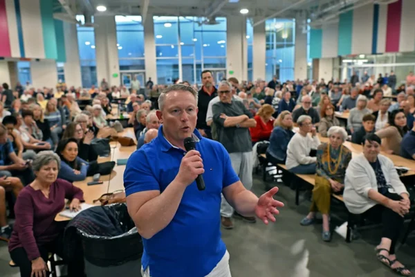 Sean McCaffrey, a candidate for Sparks City Council Ward 4, shares his thoughts at the Wingfield Springs Community meeting at the Sky Ranch Middle School cafeteria on Thursday, March 12, 2026. The meeting discussed a proposal to build housing at Red Hawk Golf property.