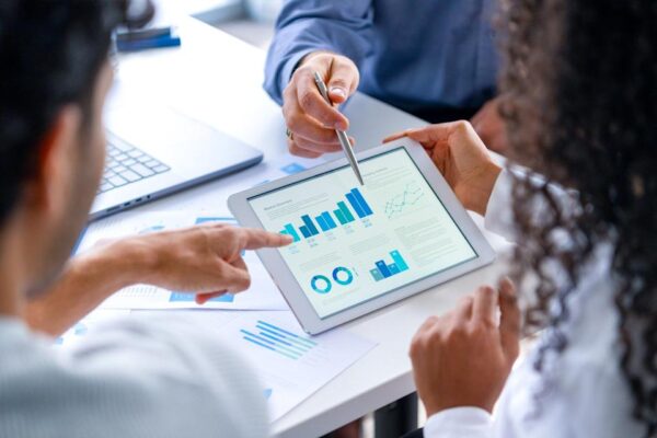 A couple looking at financial statements on a tablet.