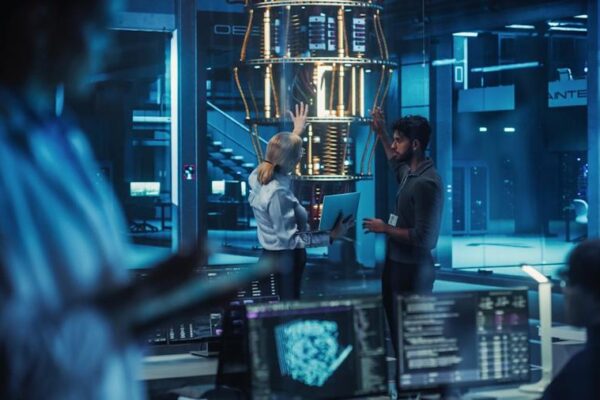 Two scientists are working on a quantum computer in a lab.