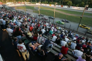 Race fans watch stock cars race during a racing event at Barberton Speedway.