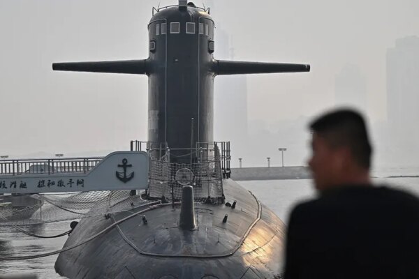 Man looks on at a Chinese submarine