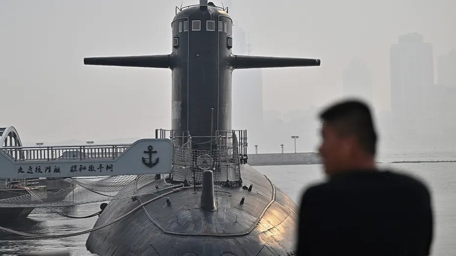 Man looks on at a Chinese submarine
