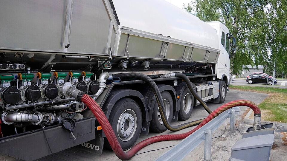 Fuel tank truck delivering fuel to petrol station.